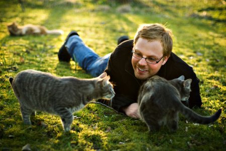 Man_playing_with_cats